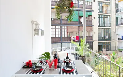 a balcony with a table with utensils on it at Great location with private terrace in Barcelona
