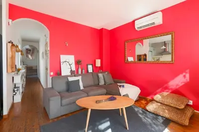 a red living room with a couch and a table at Barcelona Attic center 2 Terraces Magic views in Barcelona