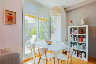 a dining room with a white table and chairs at Barcelona Attic center 2 Terraces Magic views in Barcelona