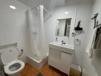 a white bathroom with a toilet and a sink at 019 principal floor in Barcelona