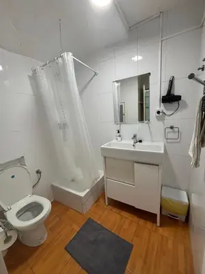 a white bathroom with a toilet and a sink at 019 principal floor in Barcelona