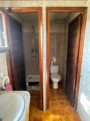 a bathroom with a tub and a toilet and a sink at Villa Agaporni in Senmanat