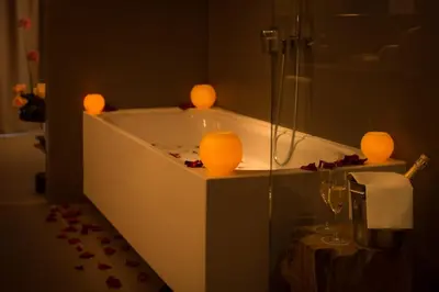 a bathroom with a tub with two lights in it at Ohla Eixample in Barcelona