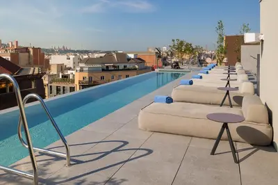 a row of beds on the roof of a building at Ohla Eixample in Barcelona