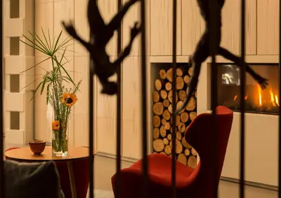 a room with a table and a chair and a vase with flowers at Ohla Eixample in Barcelona