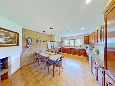 a kitchen with a table and chairs in a room at PREMIUM HABITAT Can Ferrer in Arenys de Munt