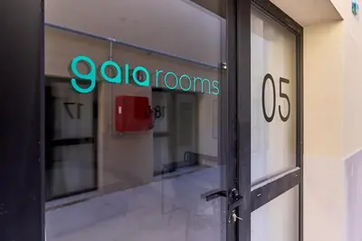 a door to a building with a sign on it at Sant Adrià Urban Suites by gaiarooms in Badalona