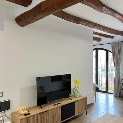 a living room with a large flat screen tv at La Casa Vella