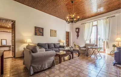 a living room with a couch and a table at Gorgeous Home In Olerdola With Private Swimming Pool, Can Be Inside Or Outside in Olerdola