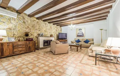 a living room with a couch and a fireplace at Gorgeous Home In Olerdola With Private Swimming Pool, Can Be Inside Or Outside in Olerdola