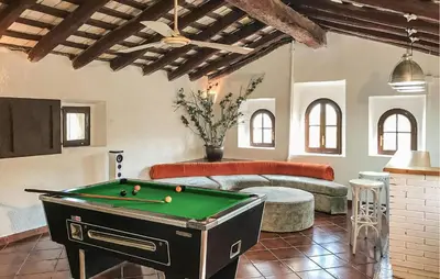 a room with a pool table and a bed at Gorgeous Home In Olerdola With Private Swimming Pool, Can Be Inside Or Outside in Olerdola