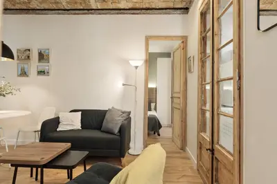 a living room with a couch and a table at Enjoy Apartments VP Camp Nou 1 in Barcelona