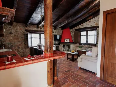 a kitchen and living room with a brick wall at Apartment Superior-Doppelsuite mit Schlafsofa by Interhome in Bigues i Riells