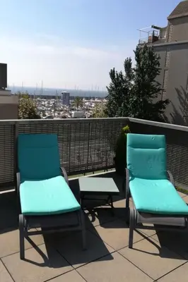 two chairs on a balcony with a view of a city at Holiday Home Haus Terrassa de Mar direkt am Strand by Interhome in Masnou