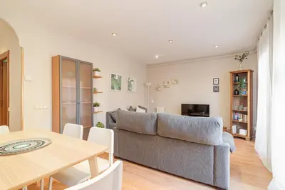 a living room with a couch and a table at 2-bedroom Bright and Classic Sagrada Familia Apartment in Barcelona