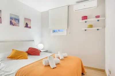 a bedroom with a bed with towels on it at 2-bedroom Bright and Classic Sagrada Familia Apartment in Barcelona