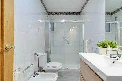 a bathroom with a shower and a toilet and a sink at 2-bedroom Bright and Classic Sagrada Familia Apartment in Barcelona