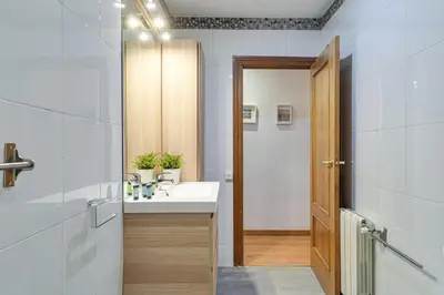 a bathroom with a sink and a mirror at 2-bedroom Bright and Classic Sagrada Familia Apartment in Barcelona