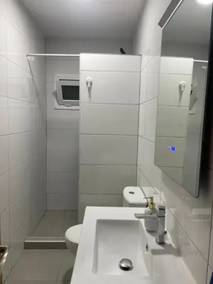 a white bathroom with a sink and a toilet at Private room next to BCN airport in El Prat de Llobregat