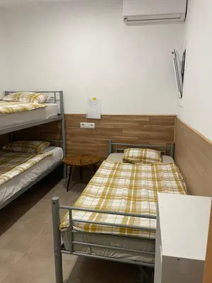 a room with two bunk beds and a table at Private room next to BCN airport in El Prat de Llobregat