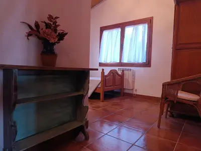 a living room with a dresser and a window at Masía Can Janàs in Lliçà d'Amunt