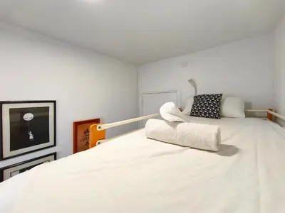 a bedroom with a large white bed in a room at Apartamento en Vilassar de Mar, Costa de Barcelona in Vilassar de Mar