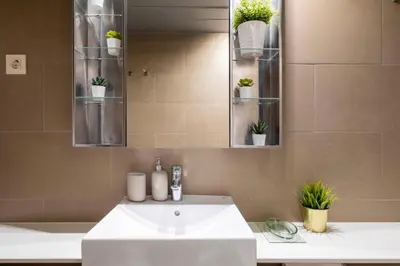 a bathroom with a white sink and a mirror at Homenfun Barcelona Fira Gran Via in Hospitalet de Llobregat