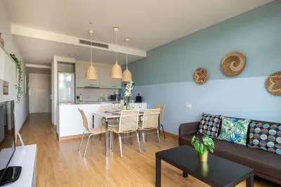 a living room with a couch and a table at Homenfun Barcelona Fira Gran Via in Hospitalet de Llobregat