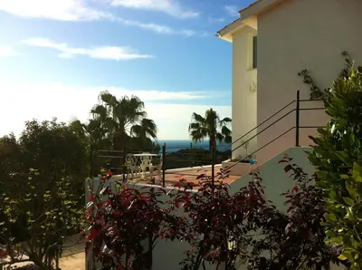 a building with a balcony with a view of the ocean at Indep suite 2 rooms in private villa views in Castelldefels