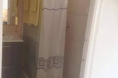 a bathroom with a shower with a white shower curtain at Independ room in villa with views 2 in Castelldefels