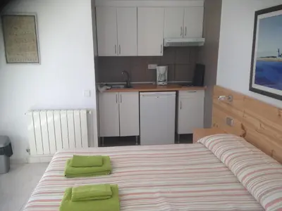 a bedroom with a large bed with green pillows on it at Independent Room in private villa with view1 in Castelldefels