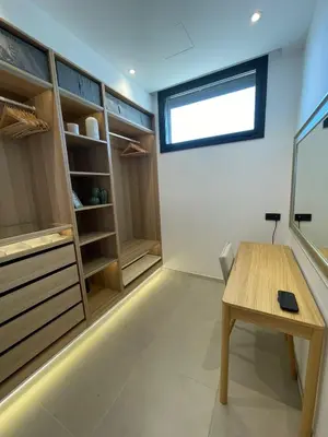a bathroom with a sink and a wooden door at Luxury sea view apartment near Sitges in Olivella