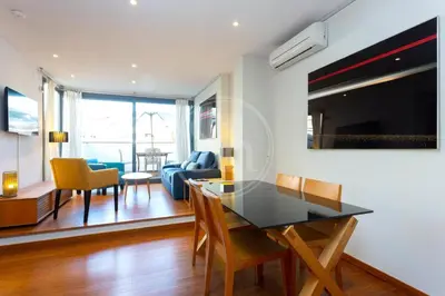 an open door in a room with a table and a chair at Bonito apartamento en Sarrià in Barcelona