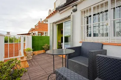 a patio with a table and chairs on a balcony at Fantastic Penthouse in Barcelona