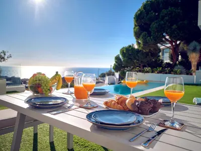 a table with glasses of wine and a plate of food at Villa in Sitges with Pool, Jacuzzi, BBQ, View, AC, 12Pax in Sitges