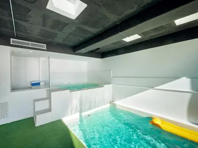 a pool with a slide in the middle of a room at Villa in Sitges with Pool, Jacuzzi, BBQ, View, AC, 12Pax in Sitges