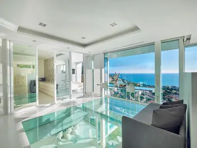 a glass floor in a house with a view of the ocean at Villa in Sitges with Pool, Jacuzzi, BBQ, View, AC, 12Pax in Sitges