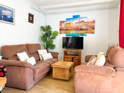 a living room with two couches and a flat screen tv at Apartment Iolanda in Vilanova i la Geltrú