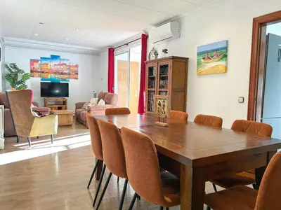 a dining room with a wooden table and chairs at Apartment Iolanda in Vilanova i la Geltrú