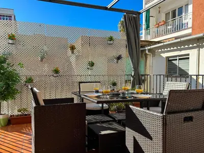 an outdoor patio with a table and chairs at Apartment Iolanda in Vilanova i la Geltrú