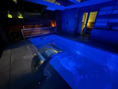 a swimming pool at night with a car in it at SuitePoolBarcelona in Vilassar de Dalt