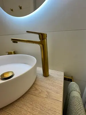 a bathroom sink with a gold faucet on a counter at SuitePoolBarcelona in Vilassar de Dalt