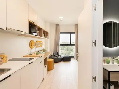 a bedroom with a large bed and a desk at Canvas Sabadell Llac in Sabadell