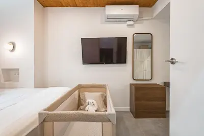 a dog sitting in a chair in a bedroom at Encantador Apartamento con Terraza en Sants in Barcelona