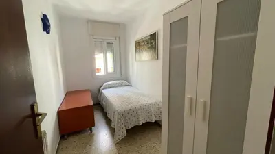 a small bedroom with a bed and a window at Maresme in Canet de Mar