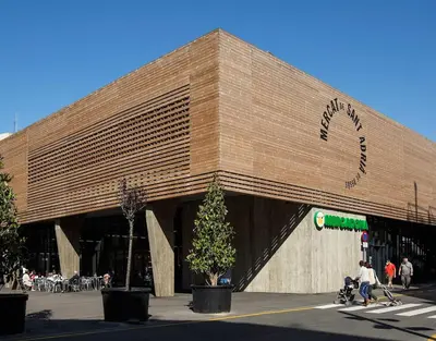 a large building with people walking in front of it at 3 min to metro Center 15 min by metro Beach 15min in Santa Coloma de Gramanet