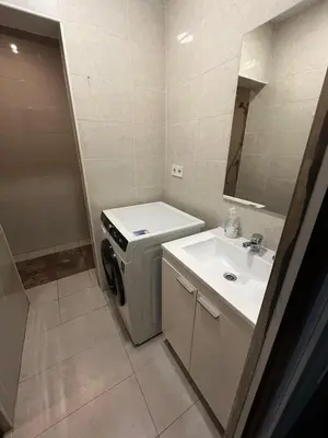 a small bathroom with a sink and a washing machine at 3 min to metro Center 15 min by metro Beach 15min in Santa Coloma de Gramanet