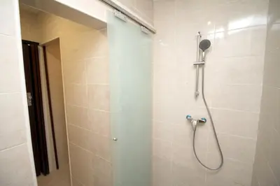 a shower with a shower head in a bathroom at 3 min to metro Center 15 min by metro Beach 15min in Santa Coloma de Gramanet