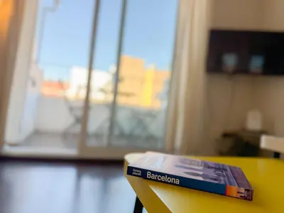 a book sitting on a table in front of a window at Boutique Remei in Barcelona