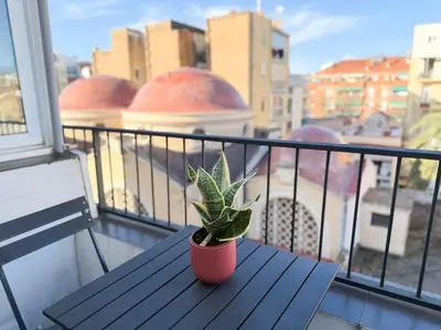 a potted plant sitting on a wooden table on a balcony at Boutique Remei in Barcelona